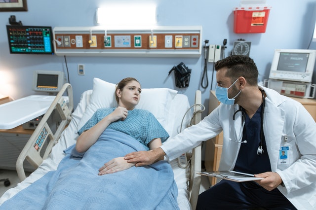 Doctor helping a patient